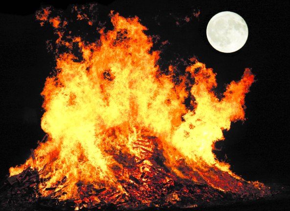 Intense flames against a moonlit sky.
